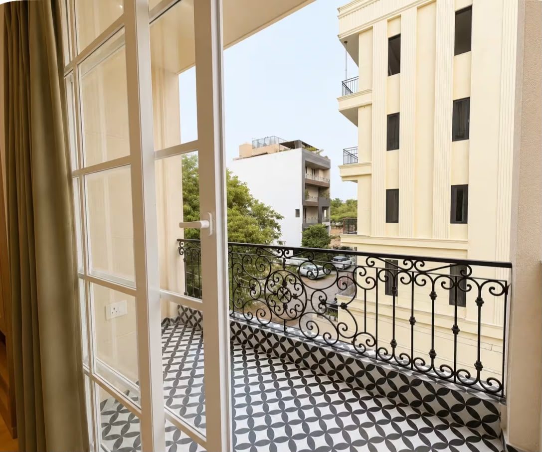Balcony with wrought-iron railing and patterned tiles