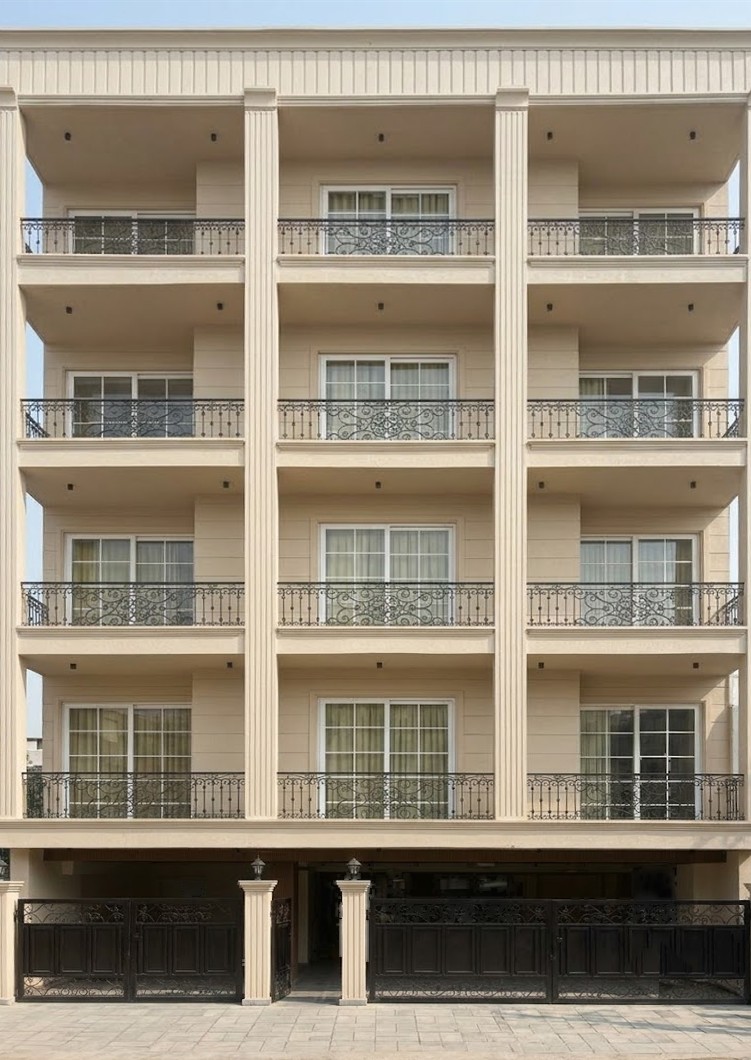Facade of the completed White Palm building with wrought-iron balconies between fluted columns